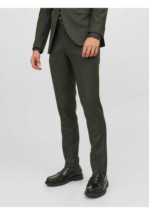 Mörkgröna skräddarsydda kostymbyxor med slim fit, avsmalnad design och subtil textur. Matchas med svarta loafers med sömnadsdetaljer.