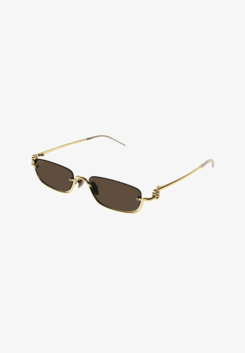 Ochelari de soare aurii cu lentile dreptunghiulare maro, având un cadru elegant, accesorii decorative pe brațele laterale și brațe subțiri.