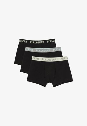Trois boxers noirs pour hommes avec taille élastique en noir, gris et blanc, tous estampillés du texte "PULL&BEAR".