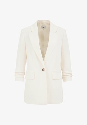 Valge ülikonna jakk, millel on üks nööp, sälguga krae, pikad varrukad, mis on inglise varrukaks üles keeratud, ja kaks esist taskut fläppidega.