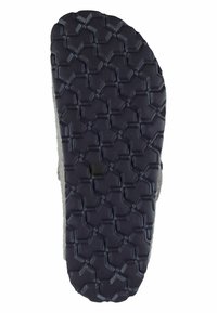 Rubber shoe sole with a textured hexagonal pattern. Gray upper material visible along the edges; design emphasizes grip and stability.