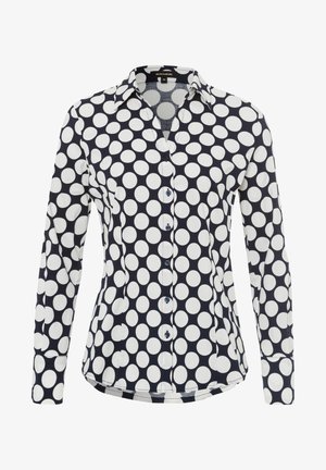 Long-sleeve shirt made of cotton, featuring a navy background with large white polka dots, a collared neckline, and button-up front.