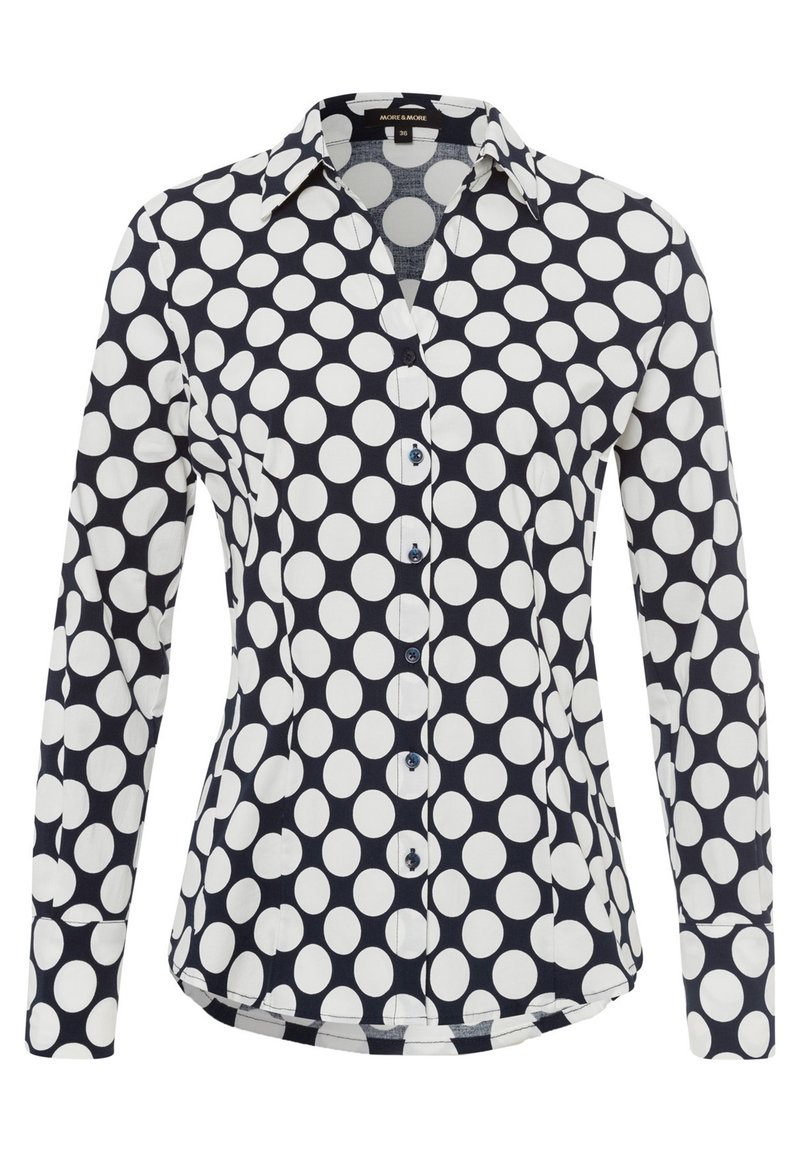 Camicia a maniche lunghe in cotone, con sfondo blu navy e grandi pois bianchi, colletto e chiusura con bottoni.