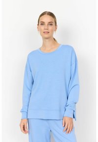 Felpa leggera azzurra a girocollo con maniche lunghe, vestibilità rilassata, spacco laterale all'orlo e texture morbida. Abbinata a un pantalone coordinato.