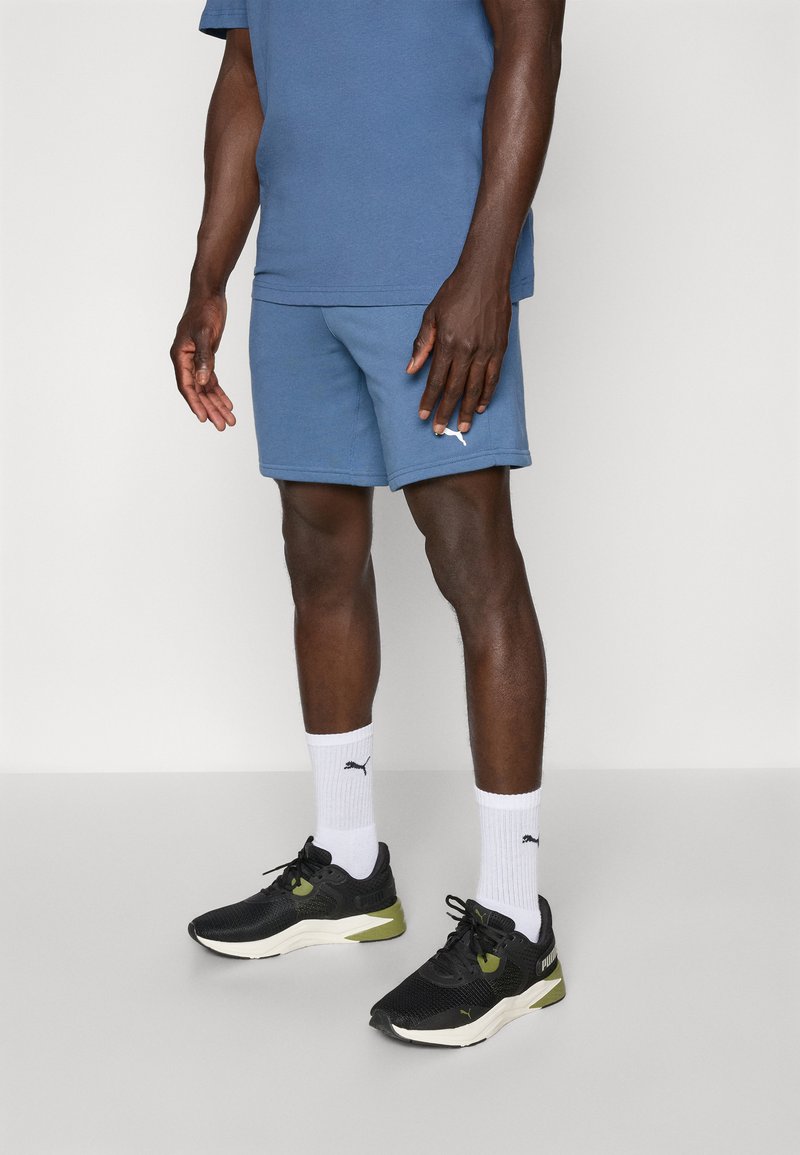 Blue cotton t-shirt and shorts set, paired with black and olive athletic shoes. White crew socks with black logo.