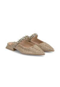 Mule beige con punta a punta caratterizzate da un design in rete adornato con strass sulla cinghia. Tacco a blocco basso con un rivestimento interno liscio.