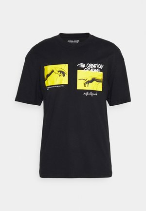 Sort bomuld t-shirt med to gule paneler med håndillustrationer og tekst, der refererer til "Adams Skabelse" af Michelangelo.