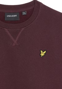 Sweatshirt bordeaux con collo rotondo, tessuto strutturato e logo di un'aquila ricamato giallo sul lato sinistro del petto.