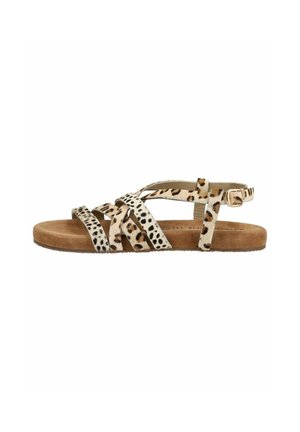 Flad sandal med brun ruskindsål og flere krydsede stropper i blandede leopard- og dalmatinermønstre, med en sidespænde.