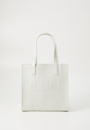 Valge tekstuuriga nahast kott, millel on kõrgendatud „TED BAKER LONDON” logo. Ruudukujuline, topeltkäepidemed ja minimalistlik disain.