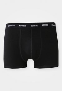 Boxeri negri din bumbac, cu un brâu elastic cu logo-ul alb "DIESEL", cusături plate și o potrivire strânsă.