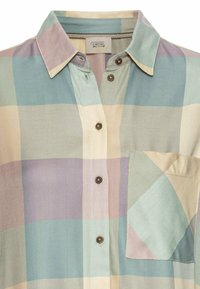 Short-sleeve, plaid shirt in pastel colors (light blue, lavender, beige) with a pocket, textured fabric, and brown buttons. Casual design.