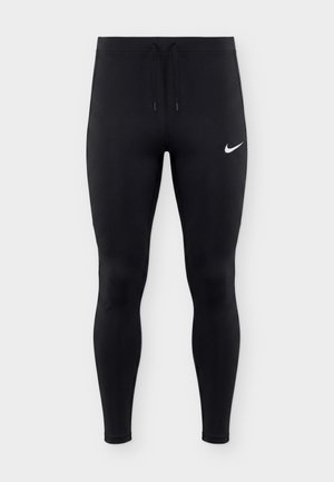 Leggings de sport noirs avec taille à cordon et logo blanc Nike Swoosh sur la partie supérieure de la cuisse gauche, affichés sur un fond uni.