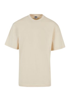 Tricou din bumbac bej, cu gât rotund și mâneci scurte, având o croială lejeră și detalii minime ale cusăturii. Design casual și versatil.