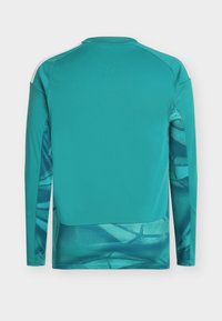 Langärmeliges Sporttrikot in Türkis mit geometrischem Muster an den Seiten. Hergestellt aus leichtem Stoff, mit rundem Ausschnitt und kontrastierenden Schultern.