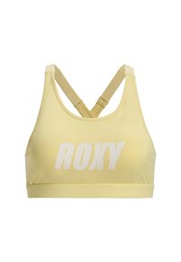 Žltá športová podprsenka vyrobená z elastického materiálu, s dizajnom racerback a bielym logom "ROXY" na prednej strane. Hladká textúra, bez vzorov.