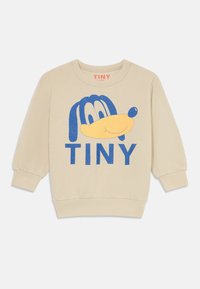 Beige Kinder-Sweatshirt mit einem blauen und gelben Cartoon-Hundegesicht und dem Wort "TINY", das unter dem Grafikdruck aufgedruckt ist.