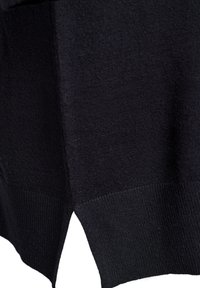 Black knitted sweater with a textured finish, featuring a ribbed hem and side slits for ease of movement.