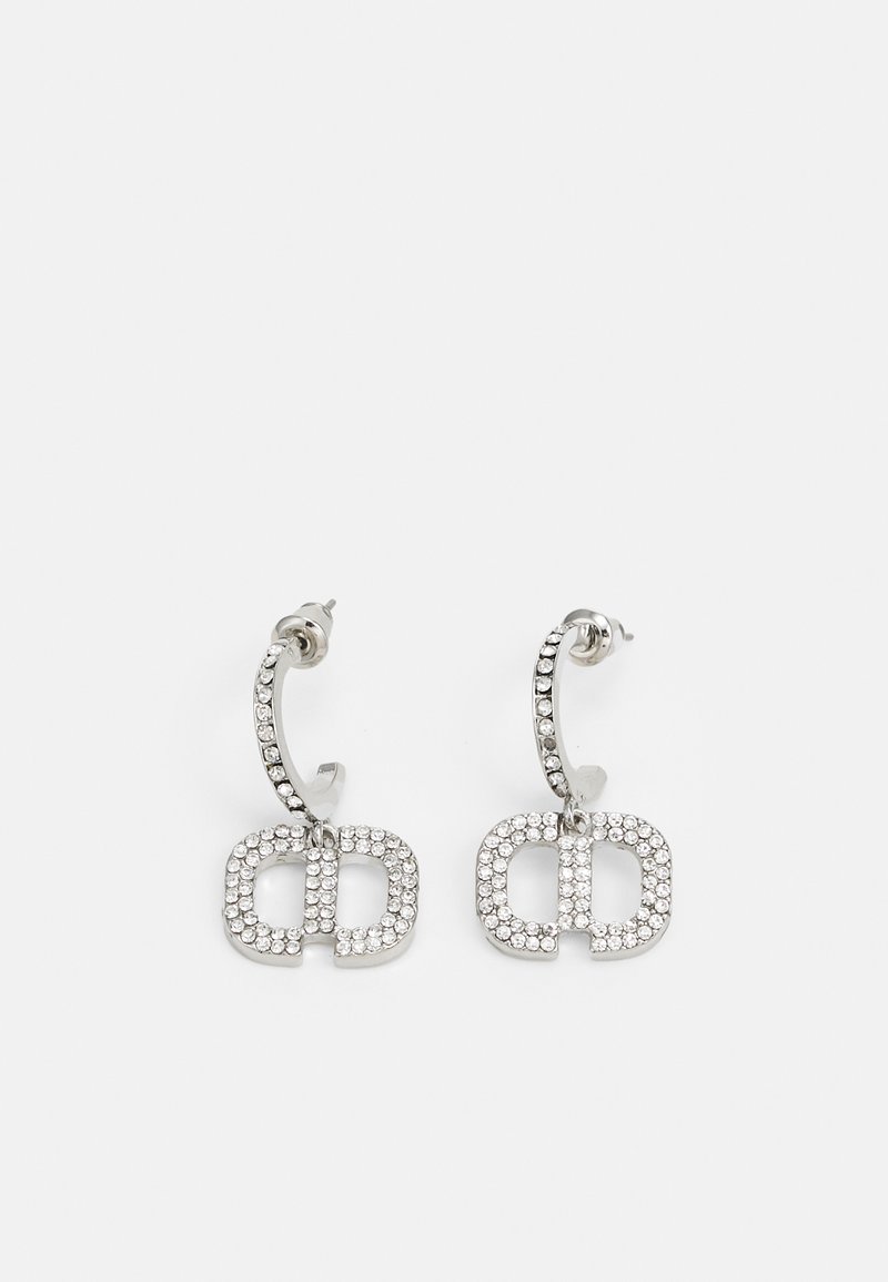 Silver earrings featuring a double "CD" design adorned with sparkling rhinestones, set on a curved hoop with a rectangular shape.