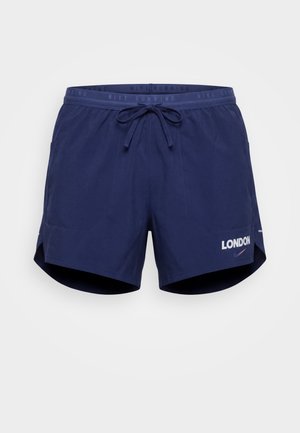 Short de running Nike bleu marine avec taille à cordon, poches latérales et « LONDON » imprimé au-dessus du logo Nike Swoosh sur la jambe gauche.