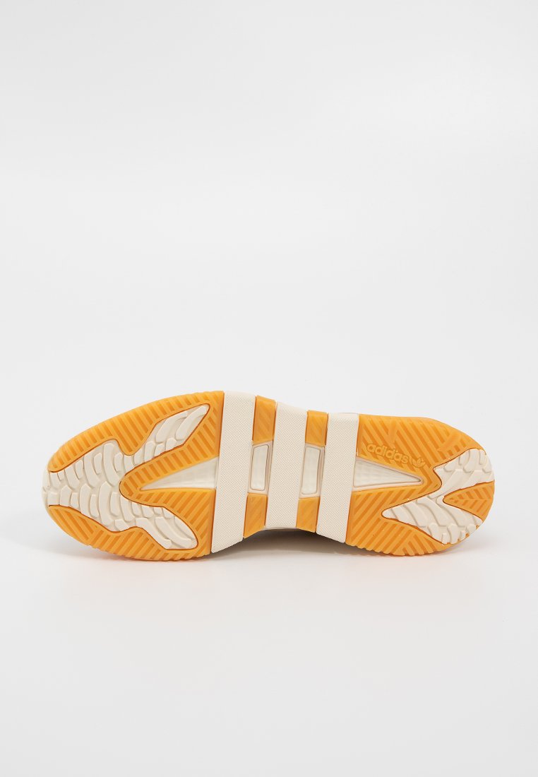 Schuhsohle mit einer orangefarbenen Gummisohle, die ein strukturiertes Muster aufweist, einer cremefarbenen Zwischensohle und drei horizontalen weißen Streifen.
