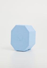 Light blue, octagonal container with a textured surface and a subtle logo on the side. Made of durable material, featuring clean lines.