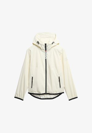 Lichtgewicht, crèmekleurige jas met een capuchon, zwarte ritsen en zijzakken. Voorzien van verstelbare trekkoorden en een langere achterkant.