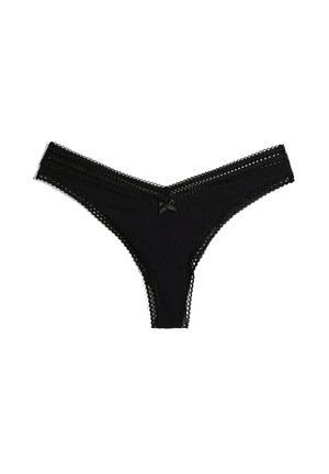String en dentelle noire avec une taille festonnée, tissu texturé et un petit nœud sur le devant. Design à dos ouvert.