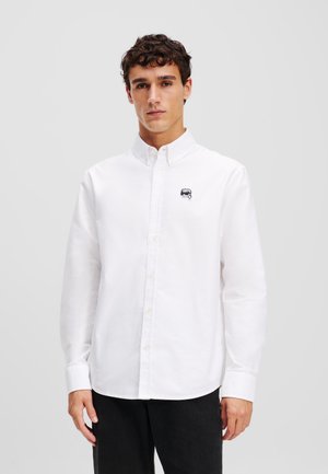 Witte button-up shirt van katoen, met lange mouwen, een kraag en een klein geborduurd logo op de borst.