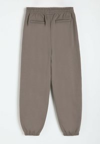 Szare spodnie dresowe z elastycznym pasem, dwiema tylnią kieszeniami oraz elastycznymi mankietami przy kostkach. Gładki, lekki materiał.