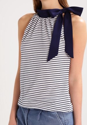 Haut à rayures blanc et bleu marine avec col tunisien froncé et nœud décoratif à l'arrière, confectionné en tissu doux.