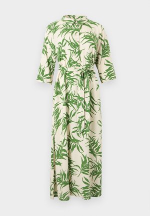 Hosszú krémszínű ruha zöld trópusi levélmintával, gombos elülső résszel, háromnegyedes ujjakkal, gallérral, oldalsó nyílásokkal és azonos anyagú derékövet.