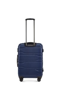 Valigia rigida navy con superficie texturizzata, maniglia laterale, manico nero retrattile e quattro ruote nere per una facile mobilità.