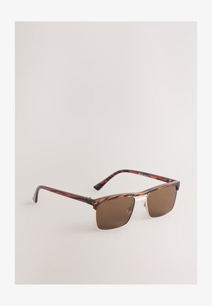 Ruudukujulised päikeseprillid pruunide toonitud läätsedega, kilpkonnamustriga raamid ja kuldsed aktsendid silla kohal. Kerge disain painduvate sangadega.