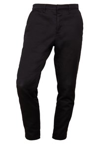 Black slim-fit pants made of cotton. Features a standard waistband, side pockets, and a smooth texture. Classic design with no patterns.