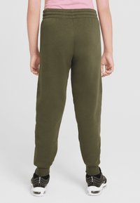 Olive green joggers with elastic waistband and cuffs, made from soft fabric, featuring a straight leg design and no visible patterns.