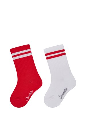 One red sock and one white sock, each with two horizontal white or red stripes near the top and "Sterntaler" text near the toe.