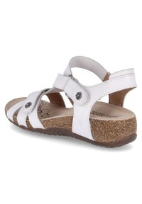 White leather sandal with adjustable straps, cork footbed, and rubber outsole. Features floral accents on strap hardware.