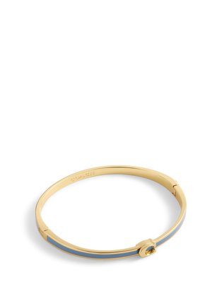 Gold-tone bangle bracelet featuring a smooth finish, a blue enamel stripe, and a circular accent with a gemstone detail.
