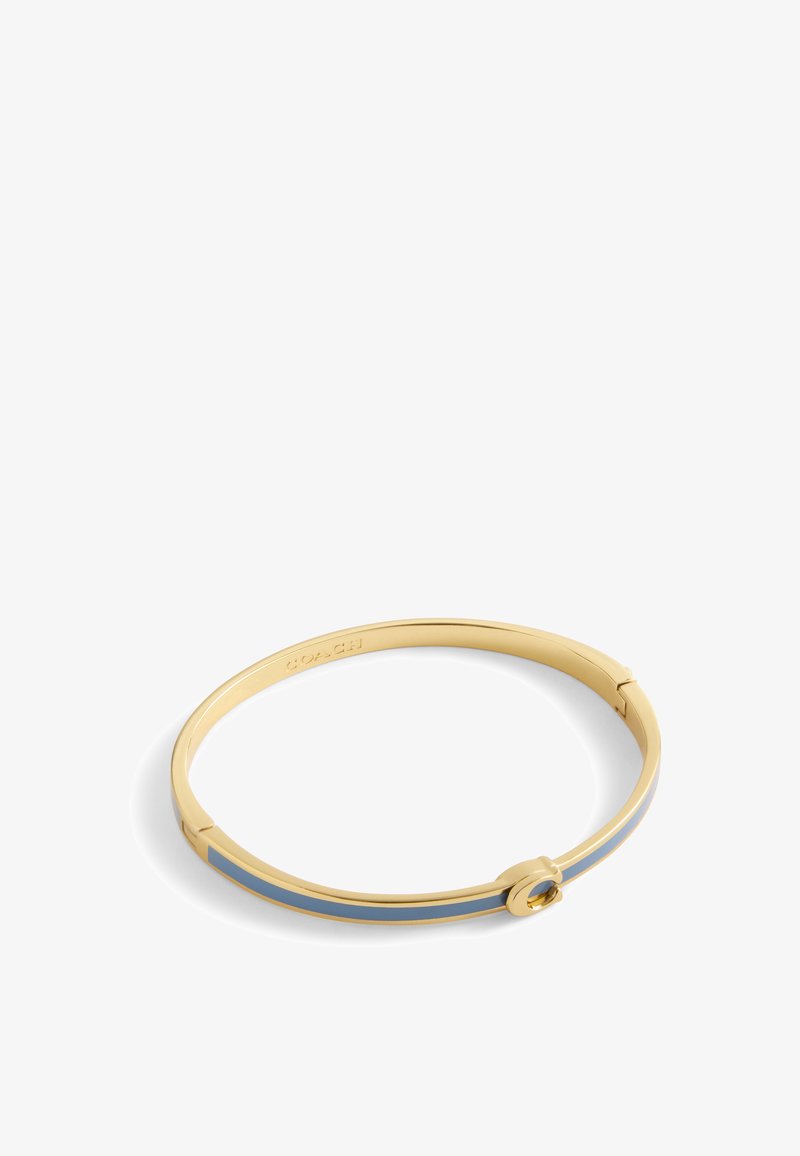 Gold-tone bangle bracelet featuring a smooth finish, a blue enamel stripe, and a circular accent with a gemstone detail.