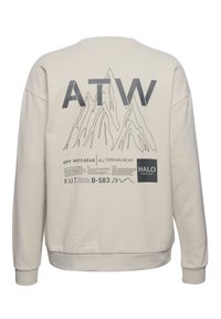 Jasnobeżowa bluza z grafiką gór oraz czarnym napisem "ATW" na plecach. Żebrowane mankiety i dół. Miękka tekstura.