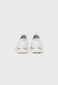Light blue athletic shoes with a textured finish, silver accents, and a cushioned sole, featuring a pull tab on the heel for easy wear.