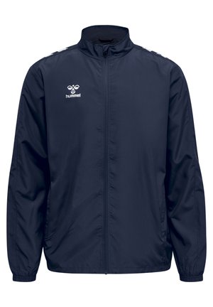 Navyblauwe windbreaker jas met een ritssluiting aan de voorkant, opstaande kraag, elastische manchetten en wit logo. Glad materiaal, lichtgewicht.