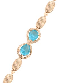Bracciale in tono oro con due gemme blu a taglio pera, intervallate da anelli ovali con superficie texture e rigata.
