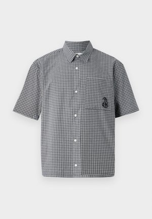 Chemise à manches courtes à carreaux noirs et blancs, avec une poche poitrine et un détail de hippocampe brodé. En matière de coton.