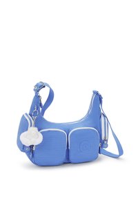 Borsa a tracolla blu realizzata in tessuto resistente, con due tasche frontali, piping bianco e un accento decorativo di un portachiavi a fiore bianco.