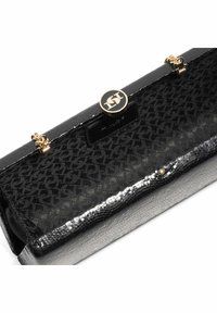 Black leather handbag with gold hardware, featuring a textured surface and a patterned interior. Closes with a round logo clasp.