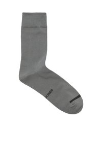 Grijze sok met een gladde textuur, een geribbeld bovenbandje en een zwarte streep detail bij de teen. Heeft subtiele branding aan de zijkant.