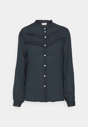 Navy blue long-sleeve blouse with a textured dot pattern, ruffled neckline, button-front closure, and lace accents on the chest.