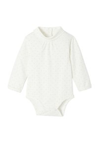 Long-sleeve bodysuit in cream with gold polka dots. Features a high collar, pleats at the neck, and snap closures at the bottom. Soft fabric.